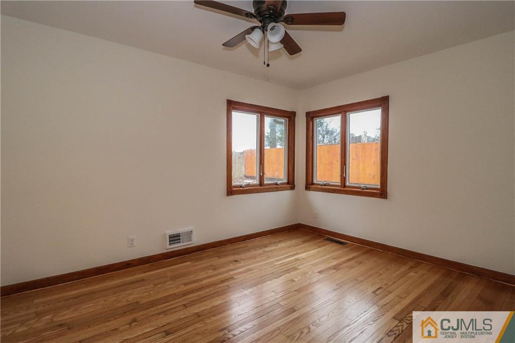 355 Chain O' Hills Road Colonia, NJ 07067 - Photo 16 of 25 a view of an empty room with wooden floor and a window