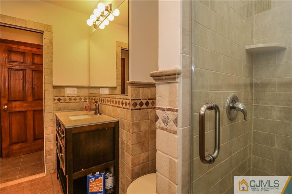355 Chain O' Hills Road Colonia, NJ 07067 - Photo 18 of 25 a bathroom with a sink a toilet and shower