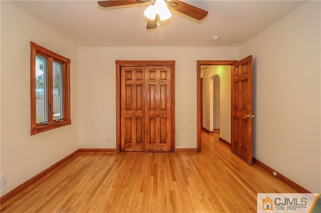 355 Chain O' Hills Road Colonia, NJ 07067 - Photo 19 of 25 an empty room with wooden floor and windows