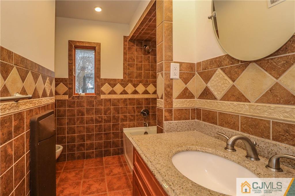 355 Chain O' Hills Road Colonia, NJ 07067 - Photo 20 of 25 a bathroom with a sink and a mirror