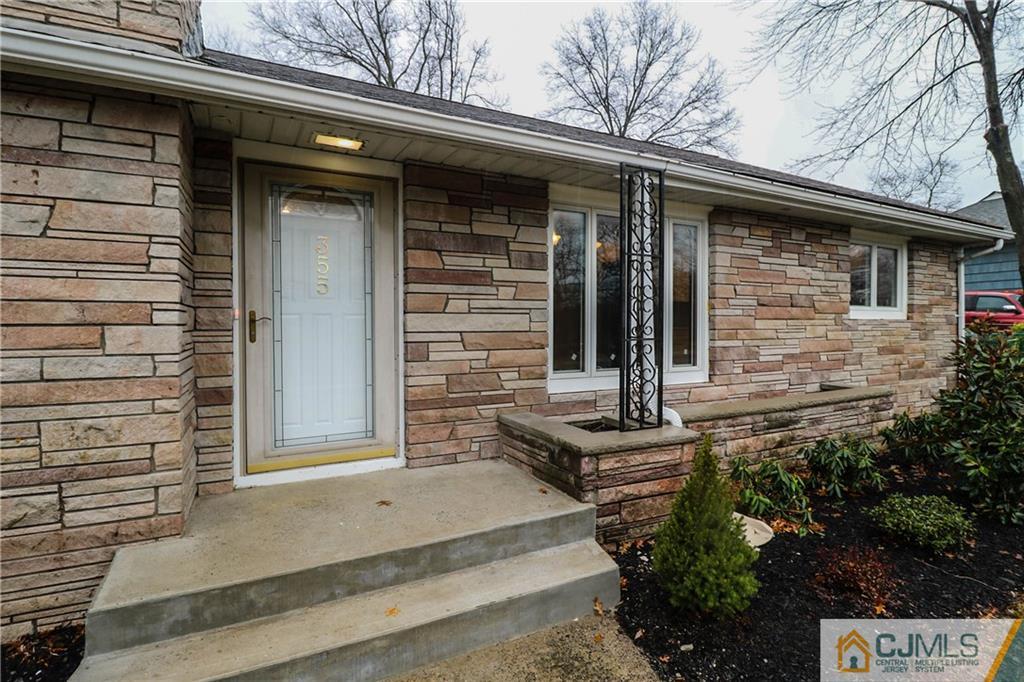 355 Chain O' Hills Road Colonia, NJ 07067 - Photo 3 of 25 a front view of a house with garden