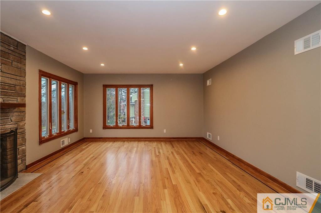 355 Chain O' Hills Road Colonia, NJ 07067 - Photo 6 of 25 a view of an empty room with glass door and wooden floor