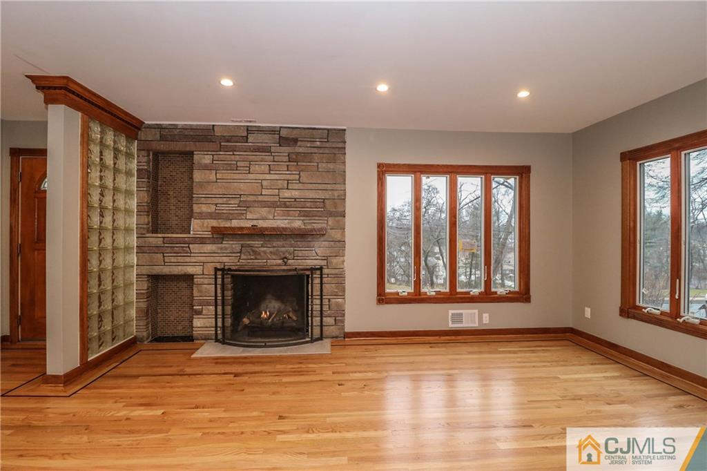 355 Chain O' Hills Road Colonia, NJ 07067 - Photo 7 of 25 a view of an empty room with a fireplace and a window