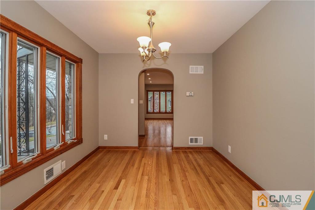 355 Chain O' Hills Road Colonia, NJ 07067 - Photo 10 of 25 a view of a room with wooden floor and chandelier