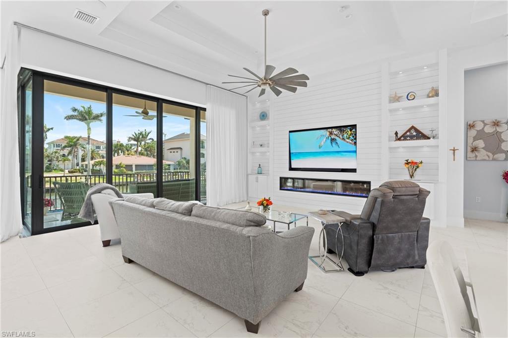 388 Pine Avenue Naples, FL 34108 - Photo 10 of 42 a living room with furniture and a flat screen tv