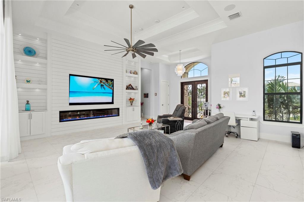 388 Pine Avenue Naples, FL 34108 - Photo 13 of 42 a living room with fireplace furniture and a flat screen tv