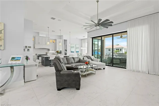 a large kitchen with kitchen island a large counter top space a sink stainless steel appliances and cabinets