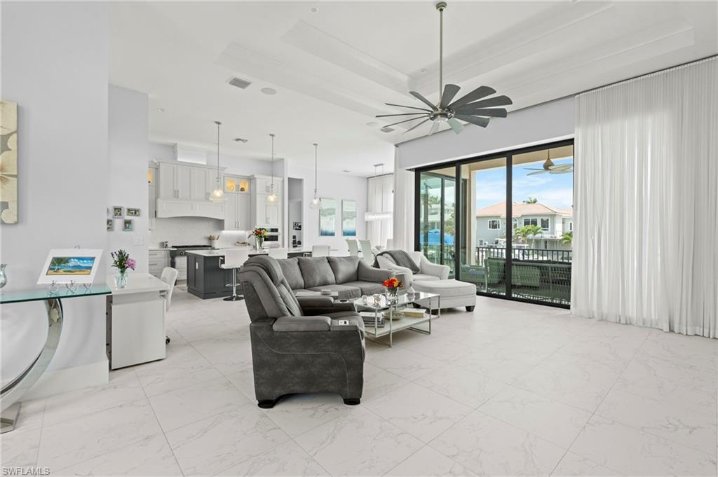 388 Pine Avenue Naples, FL 34108 - Photo 14 of 42 a living room with furniture and a large window