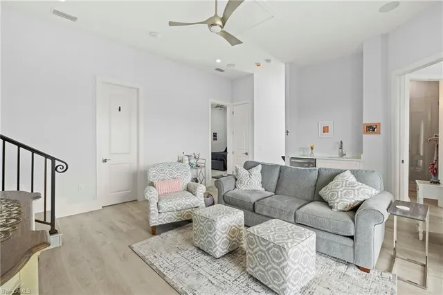 a spacious bedroom with a bed and a chandelier