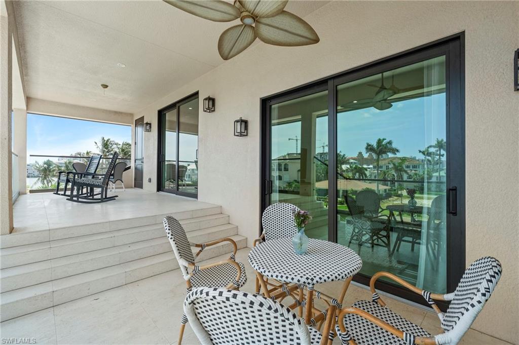 388 Pine Avenue Naples, FL 34108 - Photo 20 of 42 a dining room with furniture and a floor to ceiling window