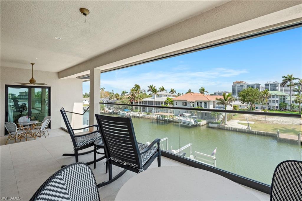 388 Pine Avenue Naples, FL 34108 - Photo 21 of 42 a view of a chairs and table in patio