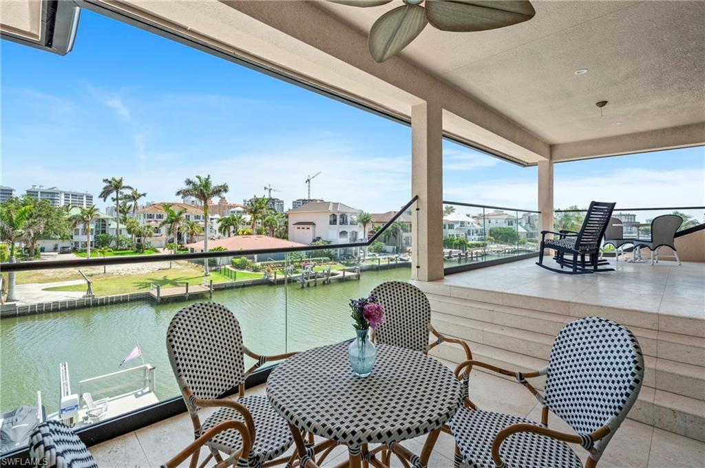 388 Pine Avenue Naples, FL 34108 - Photo 22 of 42 a view of a dining room with furniture window and wooden floor