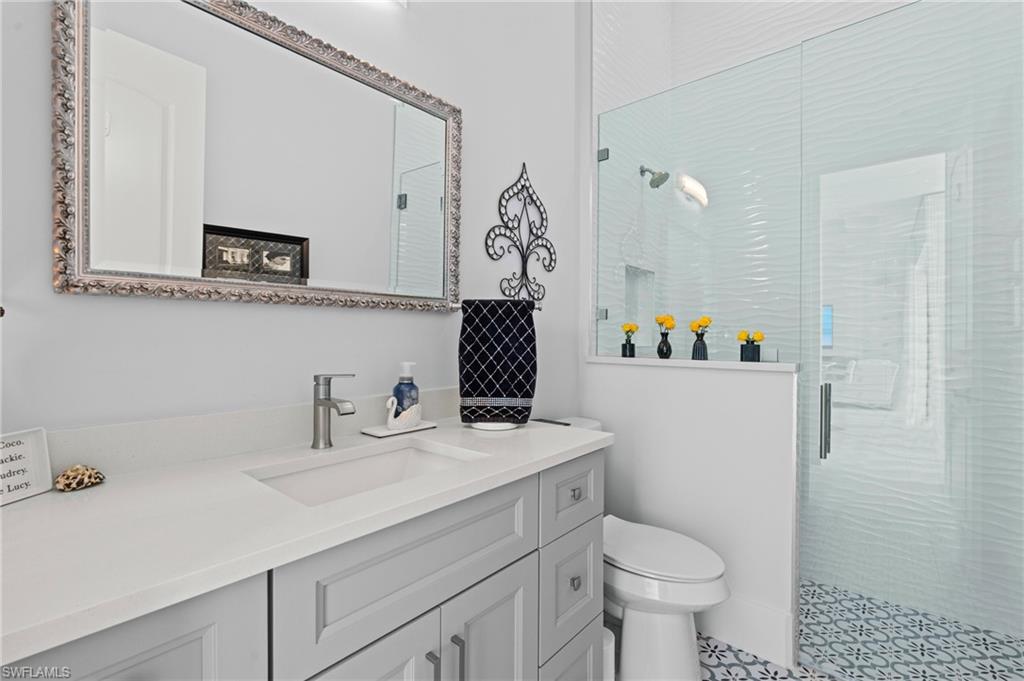 388 Pine Avenue Naples, FL 34108 - Photo 25 of 42 a bathroom with a sink toilet and a mirror