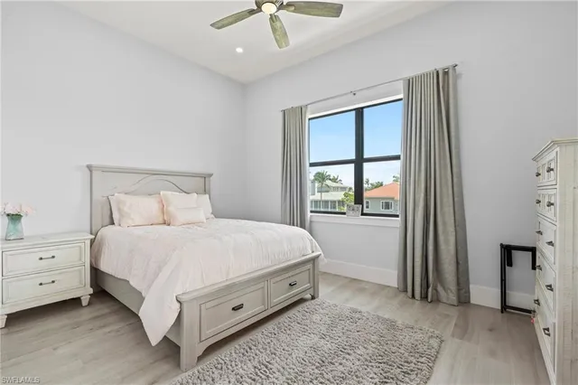 a spacious bedroom with a bed and a window