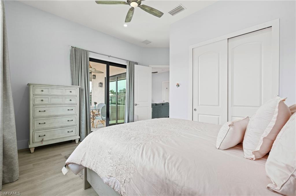 388 Pine Avenue Naples, FL 34108 - Photo 27 of 42 a large bed sitting in a bedroom chandelier
