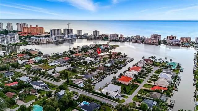 a large bed sitting in a bedroom chandelier
