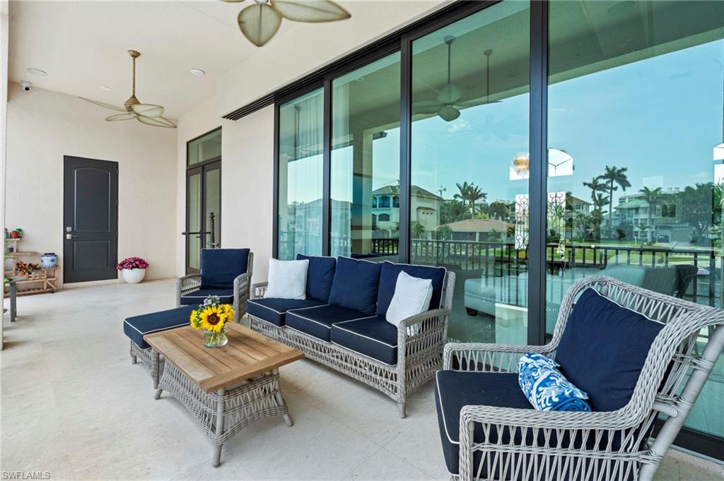 388 Pine Avenue Naples, FL 34108 - Photo 31 of 42 a living room with furniture and a floor to ceiling window