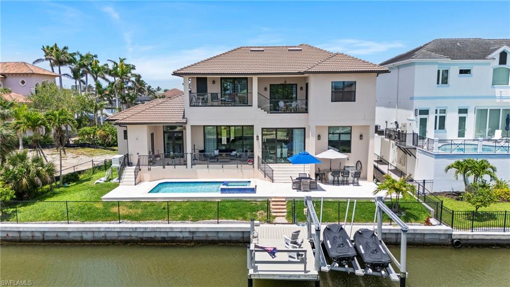 388 Pine Avenue Naples, FL 34108 - Photo 5 of 42 a front view of a house with a yard table and chairs