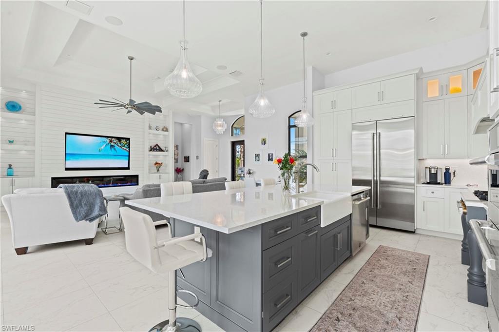 388 Pine Avenue Naples, FL 34108 - Photo 42 of 42 a large white kitchen with a stove a sink dishwasher and a refrigerator with wooden floor