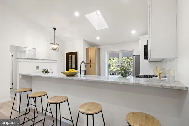 a kitchen with stainless steel appliances granite countertop a sink and a refrigerator