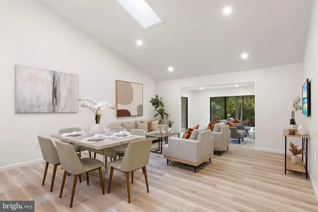 a living room with furniture dining table and wooden floor