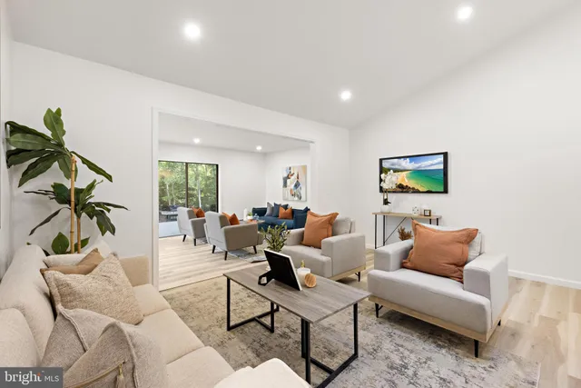a living room with furniture and a potted plant