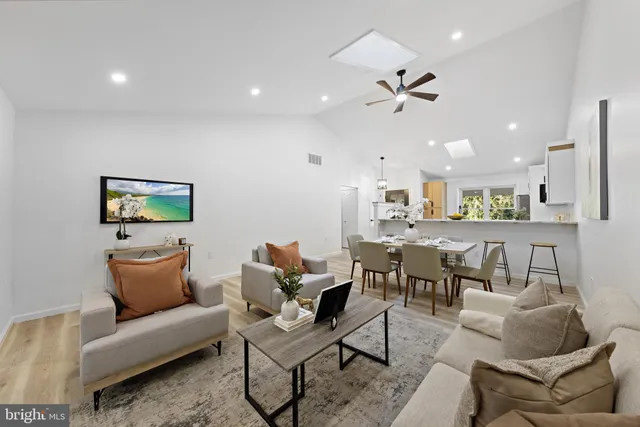a living room with furniture and kitchen view