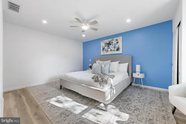 a spacious bedroom with a bed and a window