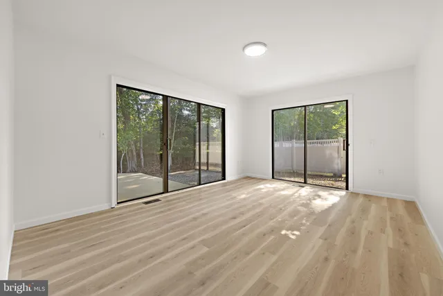 a view of an empty room with glass door