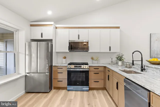 a kitchen with a sink stove and refrigerator