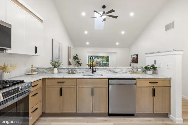 a kitchen with a sink stove and cabinets