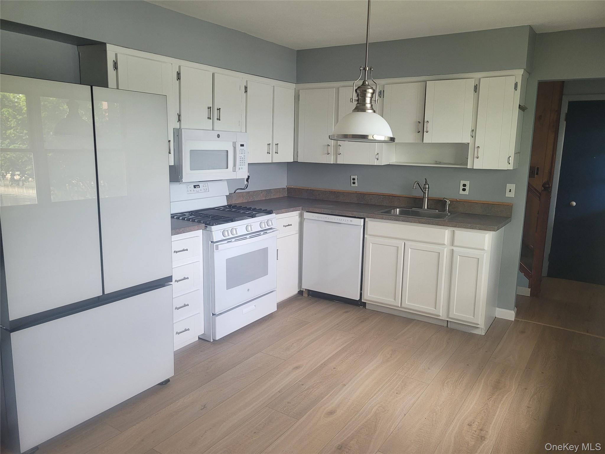 8 Cornell Road East Patchogue, NY 11772 - Photo 8 of 18 a kitchen with stainless steel appliances granite countertop a sink stove and refrigerator