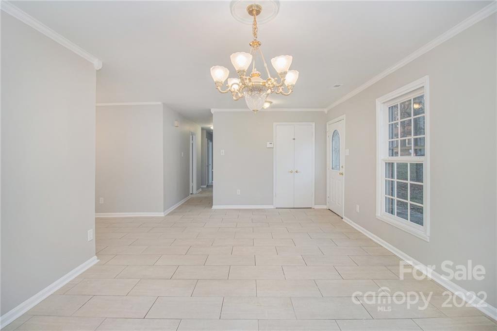 7310 Riding Trail Road Charlotte, NC 28212 - Photo 3 of 16 a view of an empty room with a window