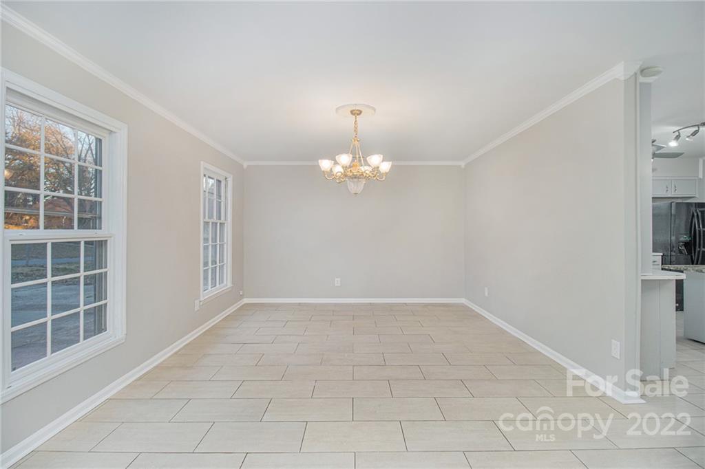 7310 Riding Trail Road Charlotte, NC 28212 - Photo 4 of 16 a view of an empty room with a window