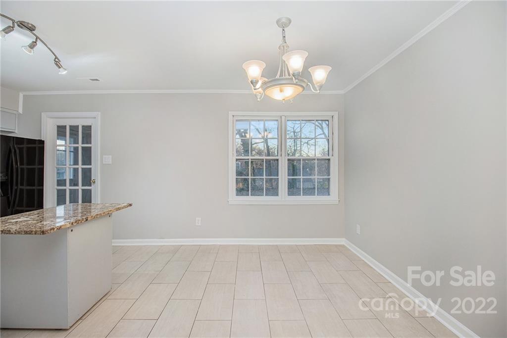 7310 Riding Trail Road Charlotte, NC 28212 - Photo 8 of 16 a view of an empty room with a window