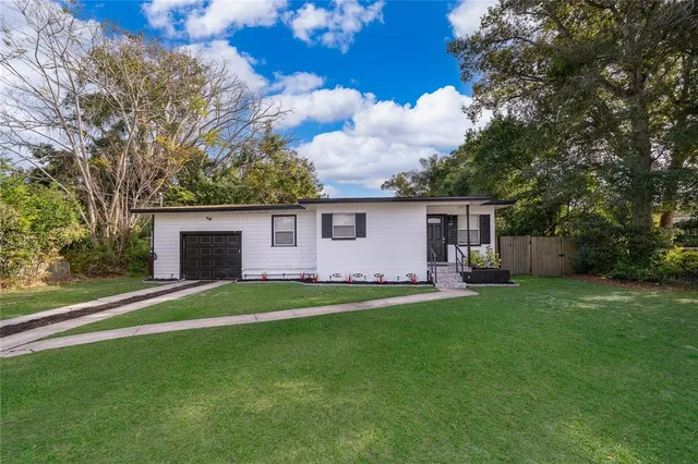 a backyard of a house with table and chairs