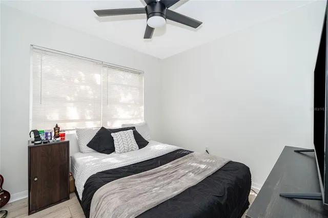 a bedroom with a bed and window