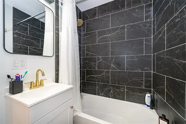 a bathroom with a bathtub a sink and a shower