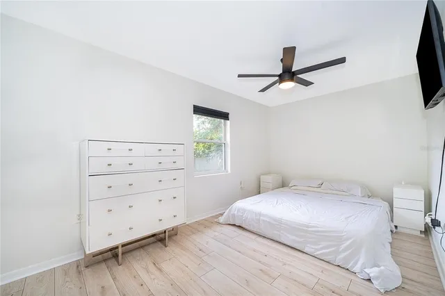 a bedroom with a bed and a flat screen tv