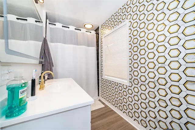 a bathroom with a sink toilet and shower