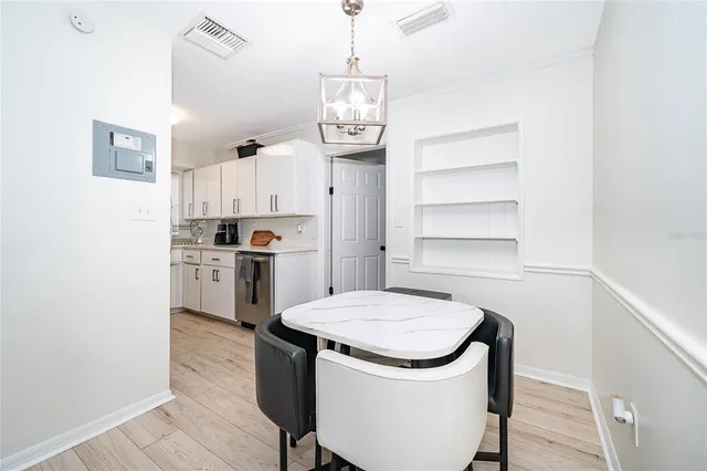 a kitchen with a sink stainless steel appliances and white cabinets