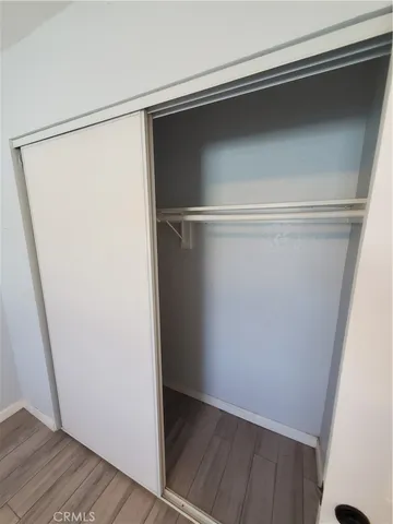 a large kitchen with a wooden floor and stainless steel appliances