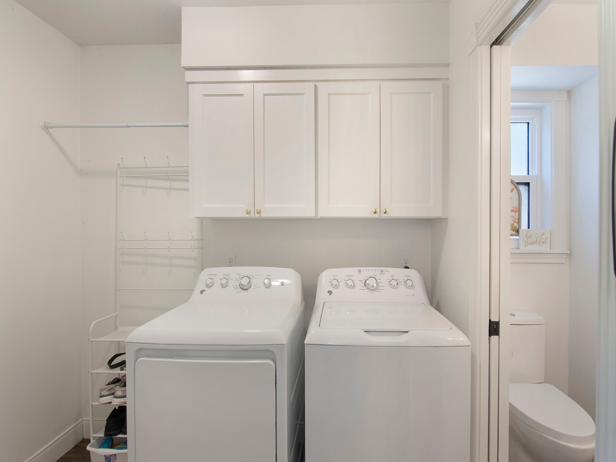 532 Raleigh Drive Conroe, TX 77302 - Photo 19 of 40 Well-appointed laundry area with storage cabinets. A pocket door leads to guest bathroom, which features a window for natural light.