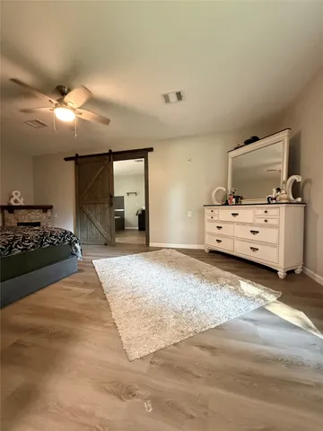 a spacious bedroom with a bed and cabinets