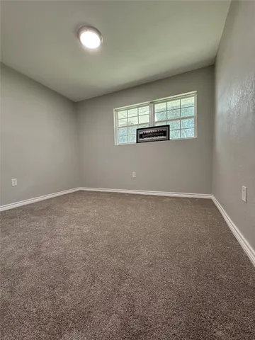 an empty room with windows and windows