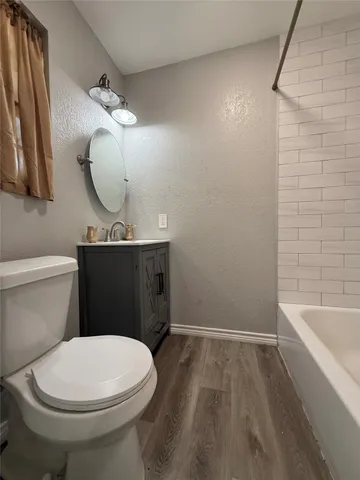 a bathroom with a toilet a sink and bathtub