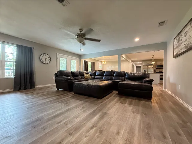 a living room with furniture and a ceiling fan