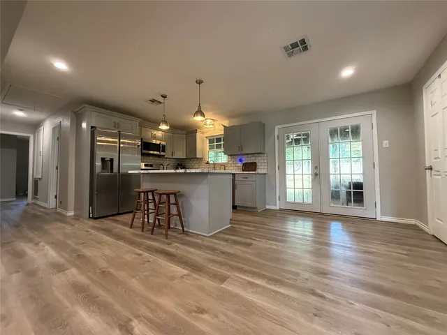 a view of a kitchen with a sink stainless steel appliances and cabinets