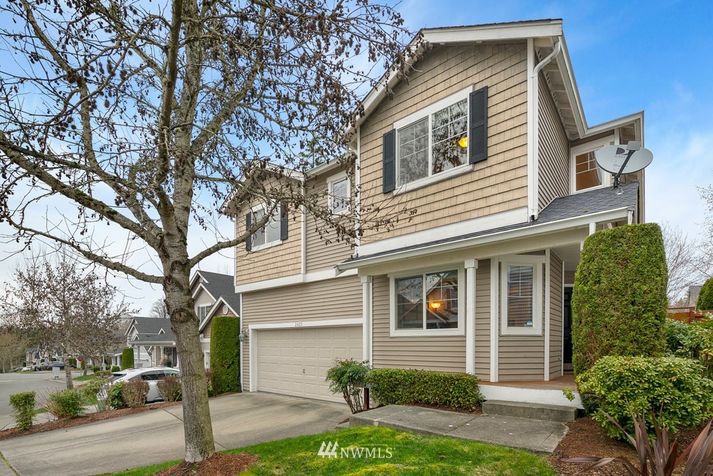 2425 194th Street Southeast, Unit 40 Bothell, WA 98012 - Photo 1 of 20 a front view of a house with a yard and garage