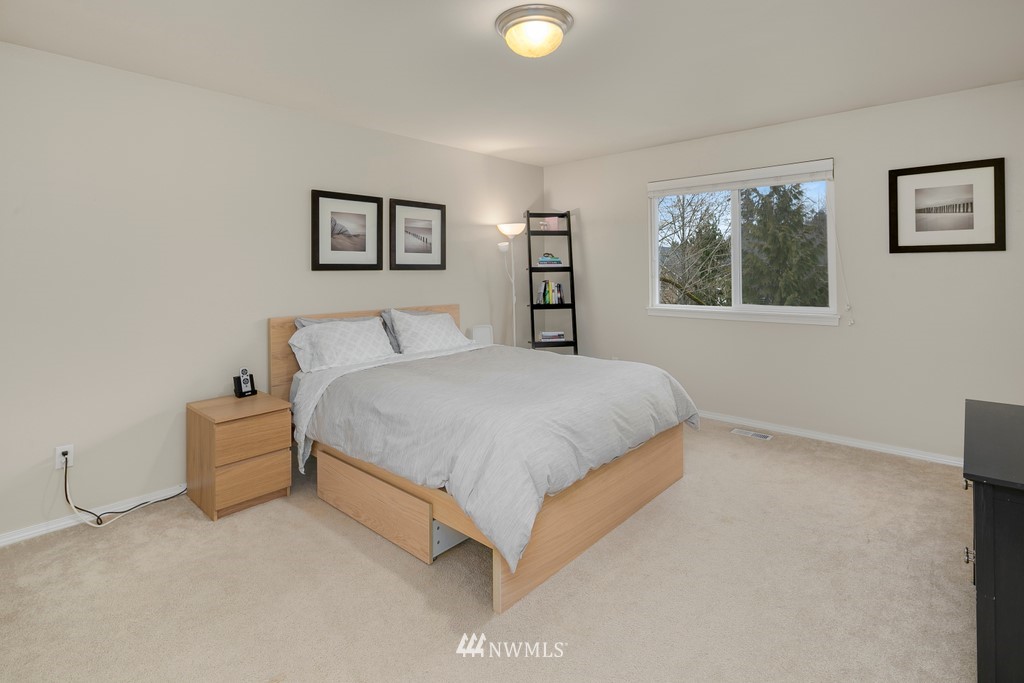2425 194th Street Southeast, Unit 40 Bothell, WA 98012 - Photo 13 of 20 a spacious bedroom with a bed and a couch